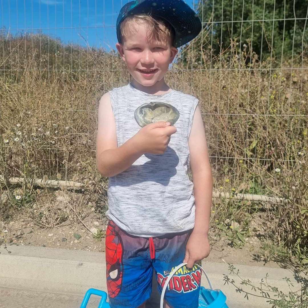 Winston Archer and the shell he found after visiting Dymchurch beach. Picture: Candy Archer