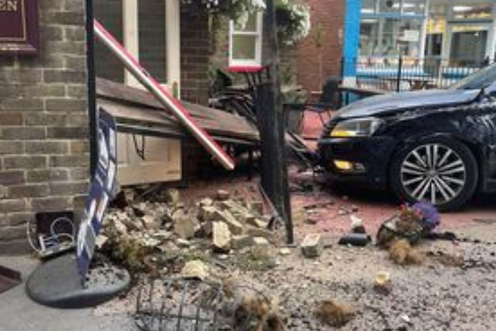 The crumpled car ploughed into the pub garden