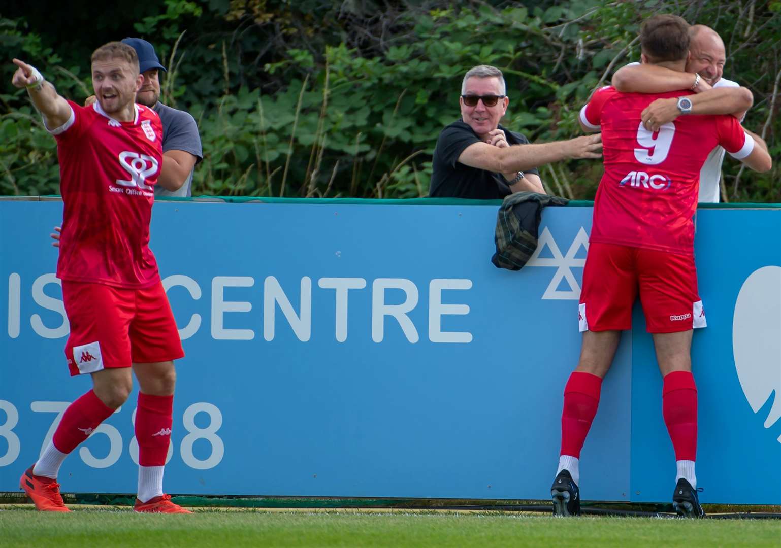 Faversham striker Gary Lockyer hugs vice-chairman Marc Leader after his debut goal. Picture: Ian Scammell