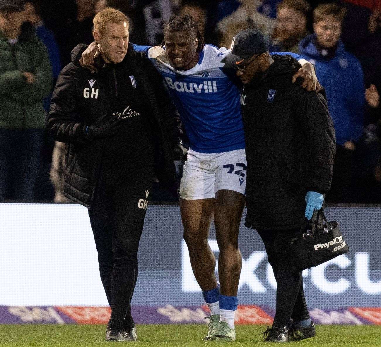 Injured Gillingham defender Shadrach Ogie is helped off the field at the end of the first half. Picture: Beau Goodwin