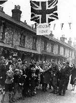 A soldier is congratulated by grateful families