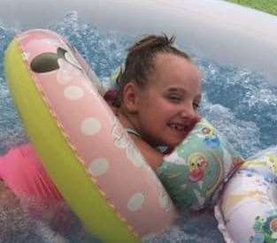 The little girl used the tub for hydrotherapy and to splash around in