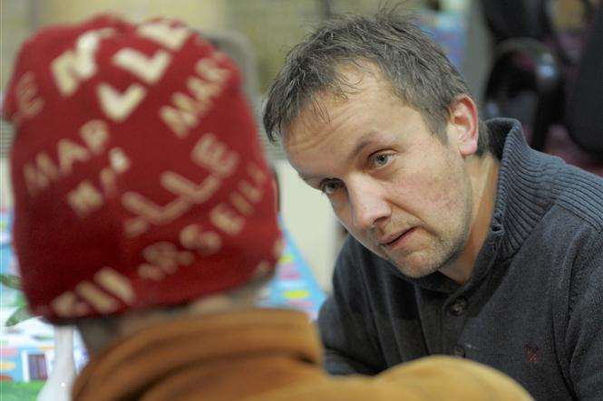 Food bank worker Wym Mauritz talks with a client at St Mark's Church, Gillingham, a distribution point