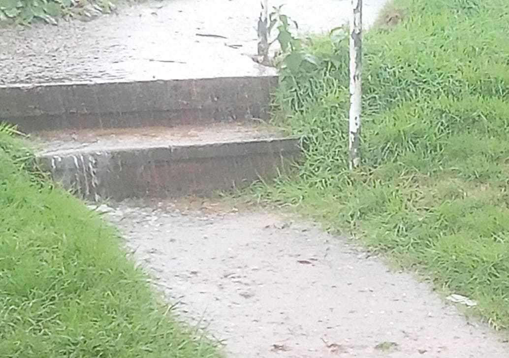 Water falling over the steps to the flat in Butchers Lane, Kings Hill. Picture: Richard Glass