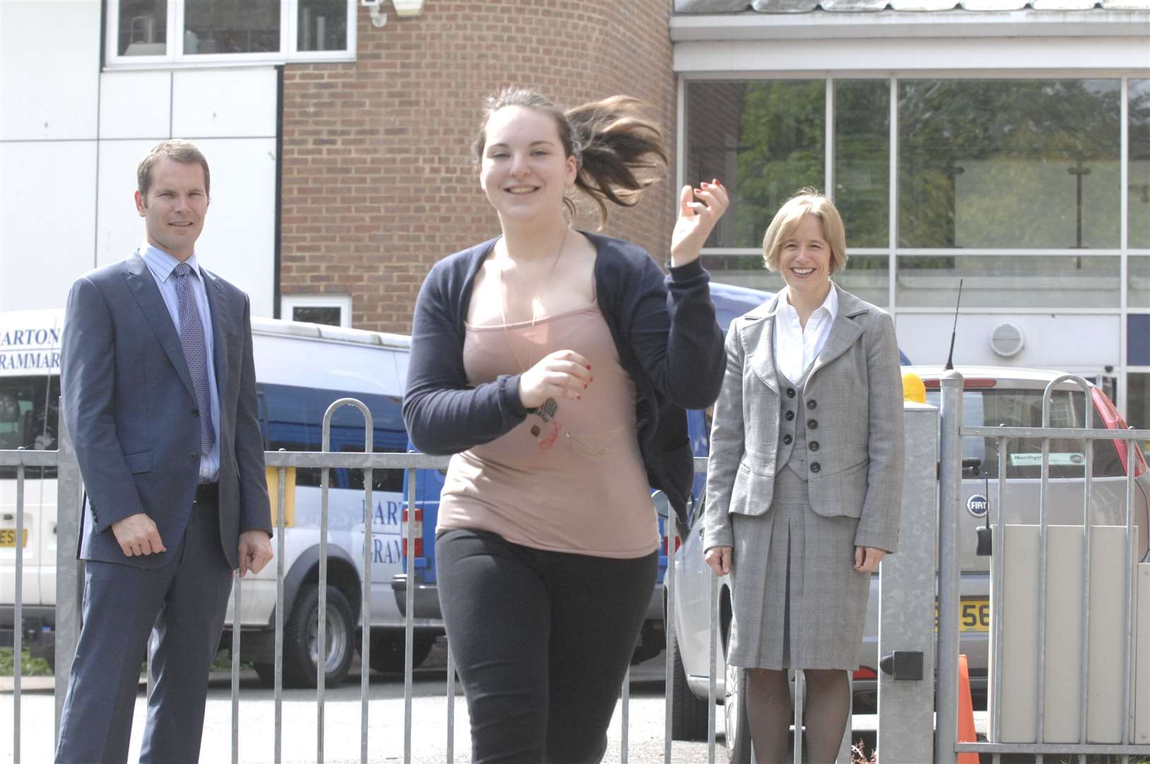 Lois Ghost, a pupil at Barton Court Grammar School, rehearses the torchbearer role, watched on by assistant head Richard Morgan and head teacher Kirstin Cardus