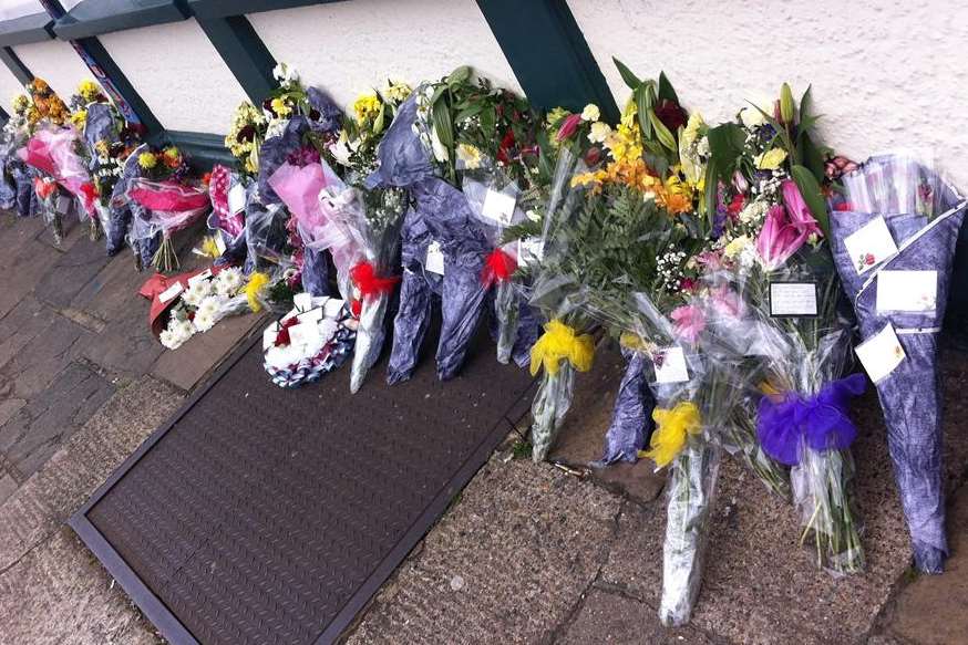 Flowers laid outside Dartford pub The Woodman