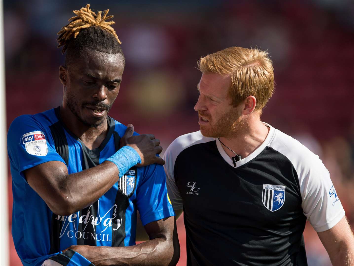 Gillingham's Gabriel Zakuani goes off with a shoulder injury. Picture: Ady Kerry