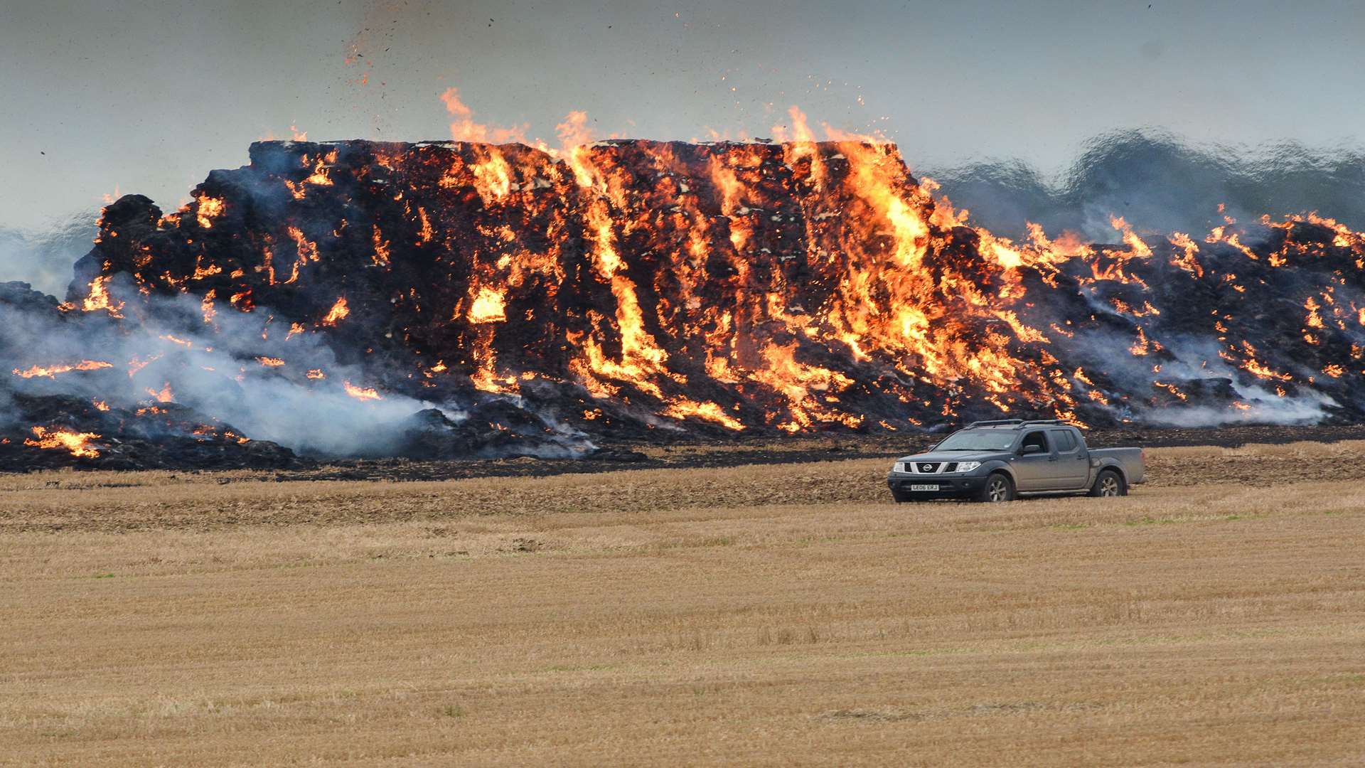 Stock Image: A large haystack ignited in flames in a field in Eythorne two years ago