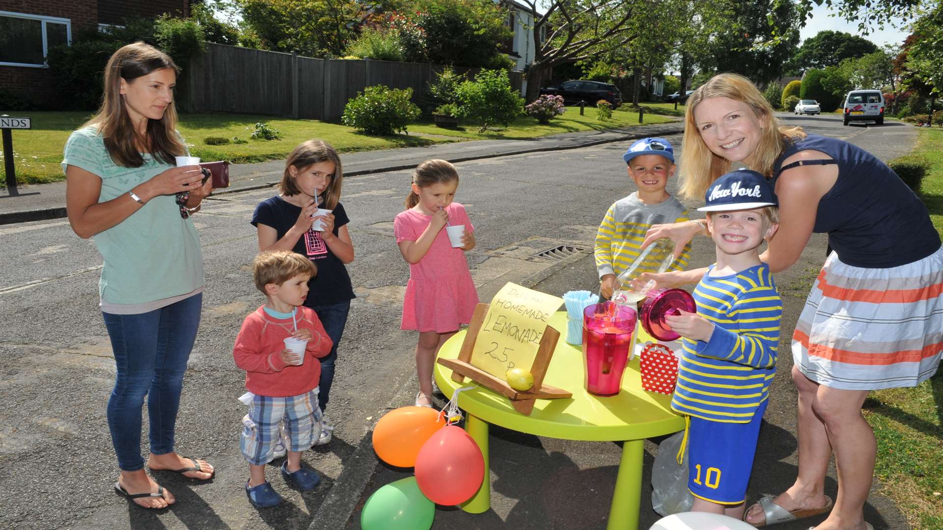 Ethan, 7 and Isaac, 5 with mum Lucy, sold their lemonade to local people and even cyclists passing through