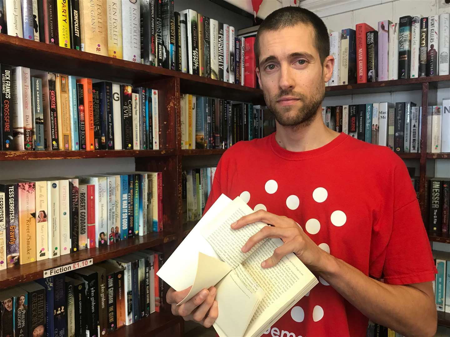 Demelza store manager Nick Rogers with one of the vandalised books