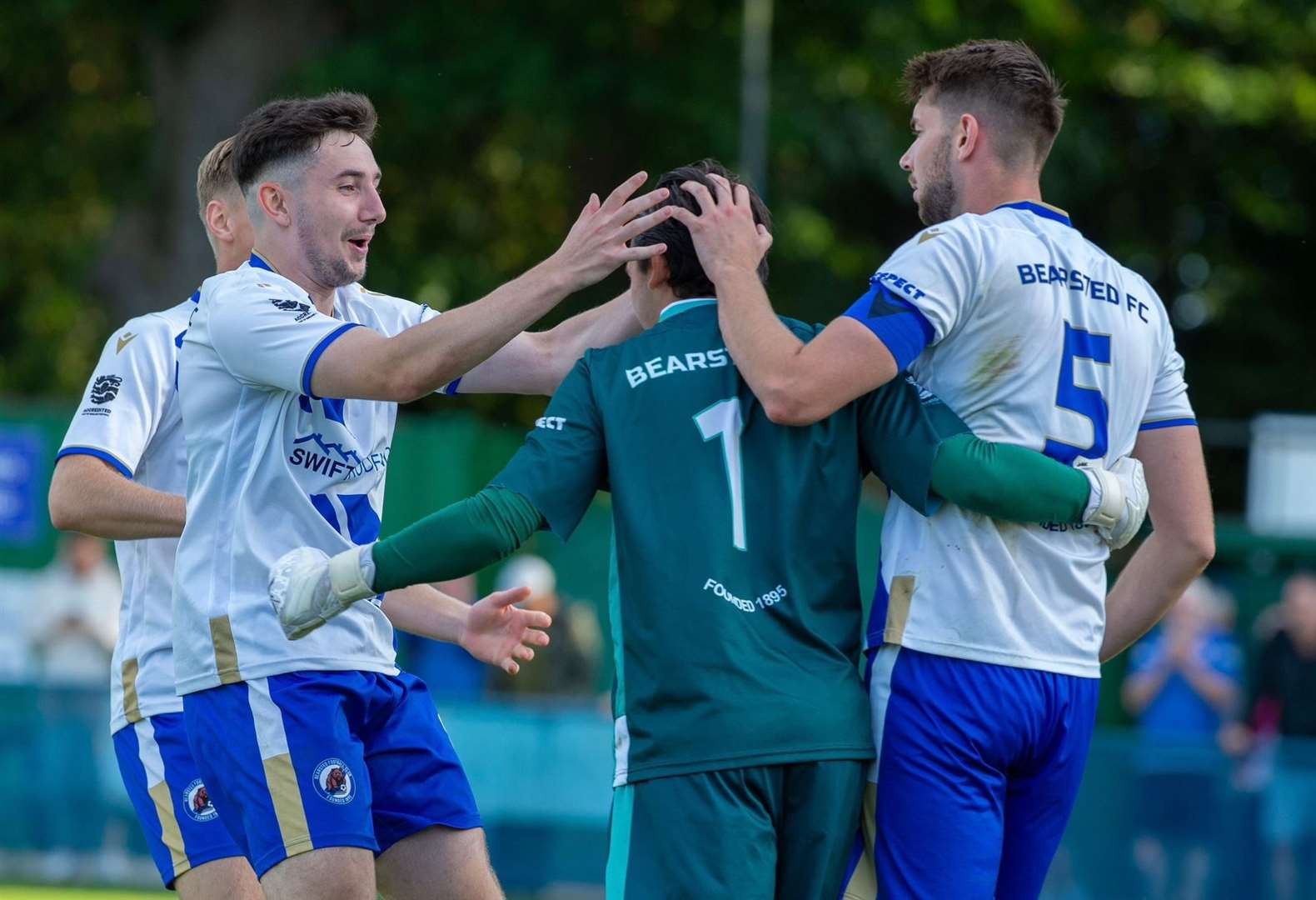 Bearsted players congratulate penalty shoot-out hero Frankie Leonard. Picture: Ian Scammell