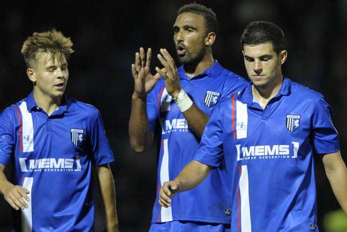 John Egan, right, leaves the field after his own goal ended Gillingham's Capital One Cup run at home to Newcastle Picture: Barry Goodwin