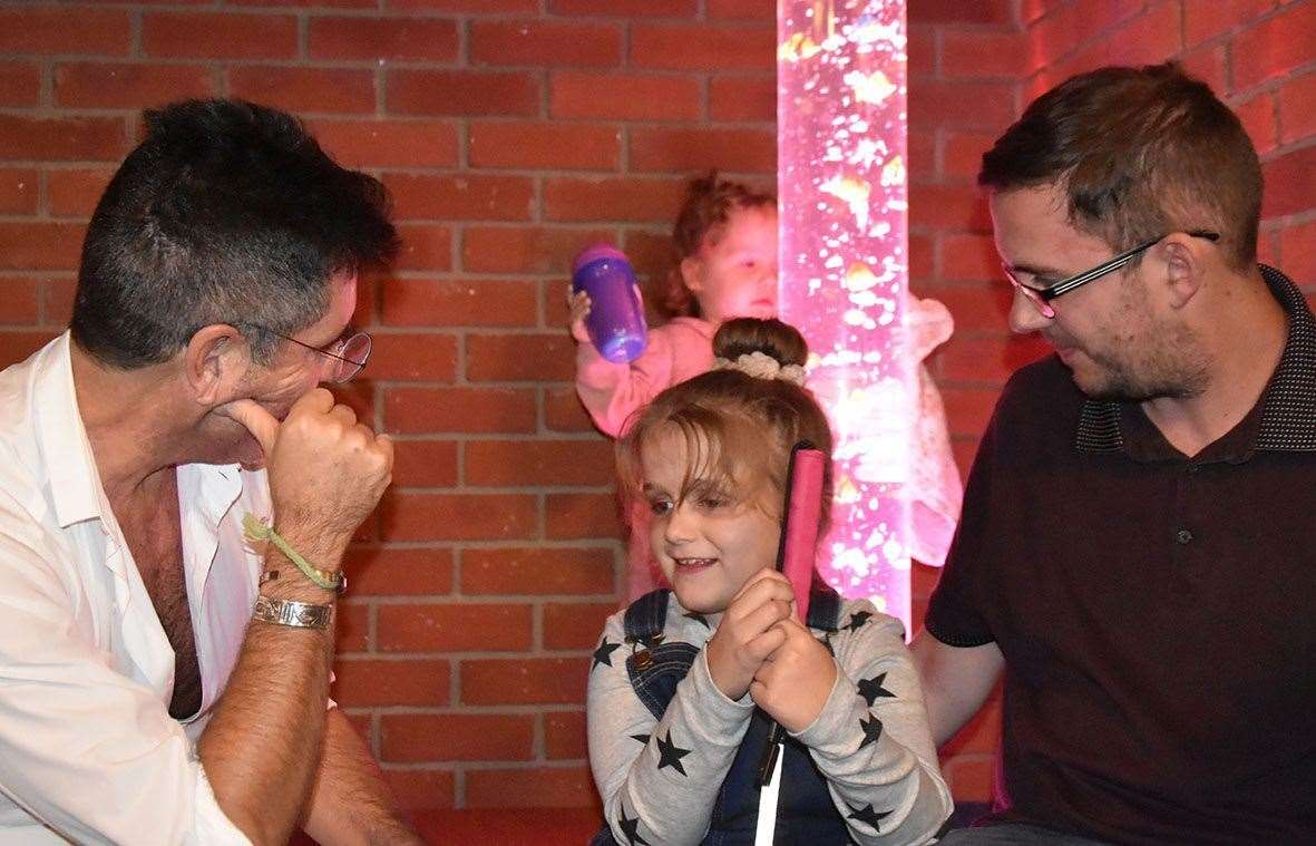 Hallie with X-Factor judge Simon Cowell. Pic: Demelza Children's Hospice