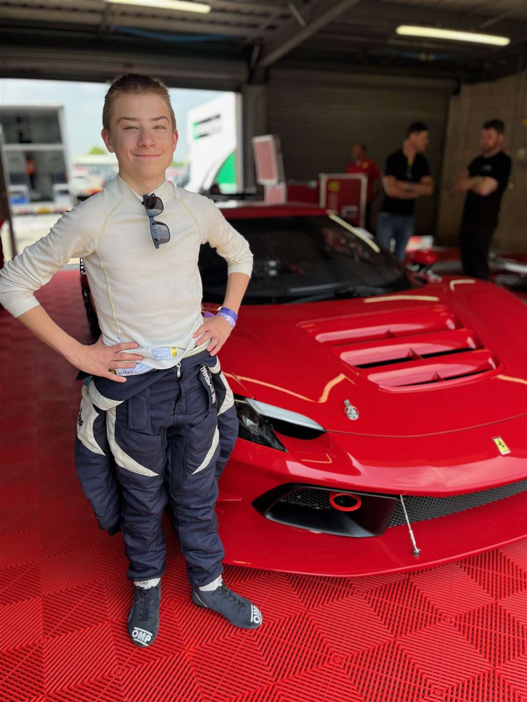 Thomas Merritt alongside a Ferrari.