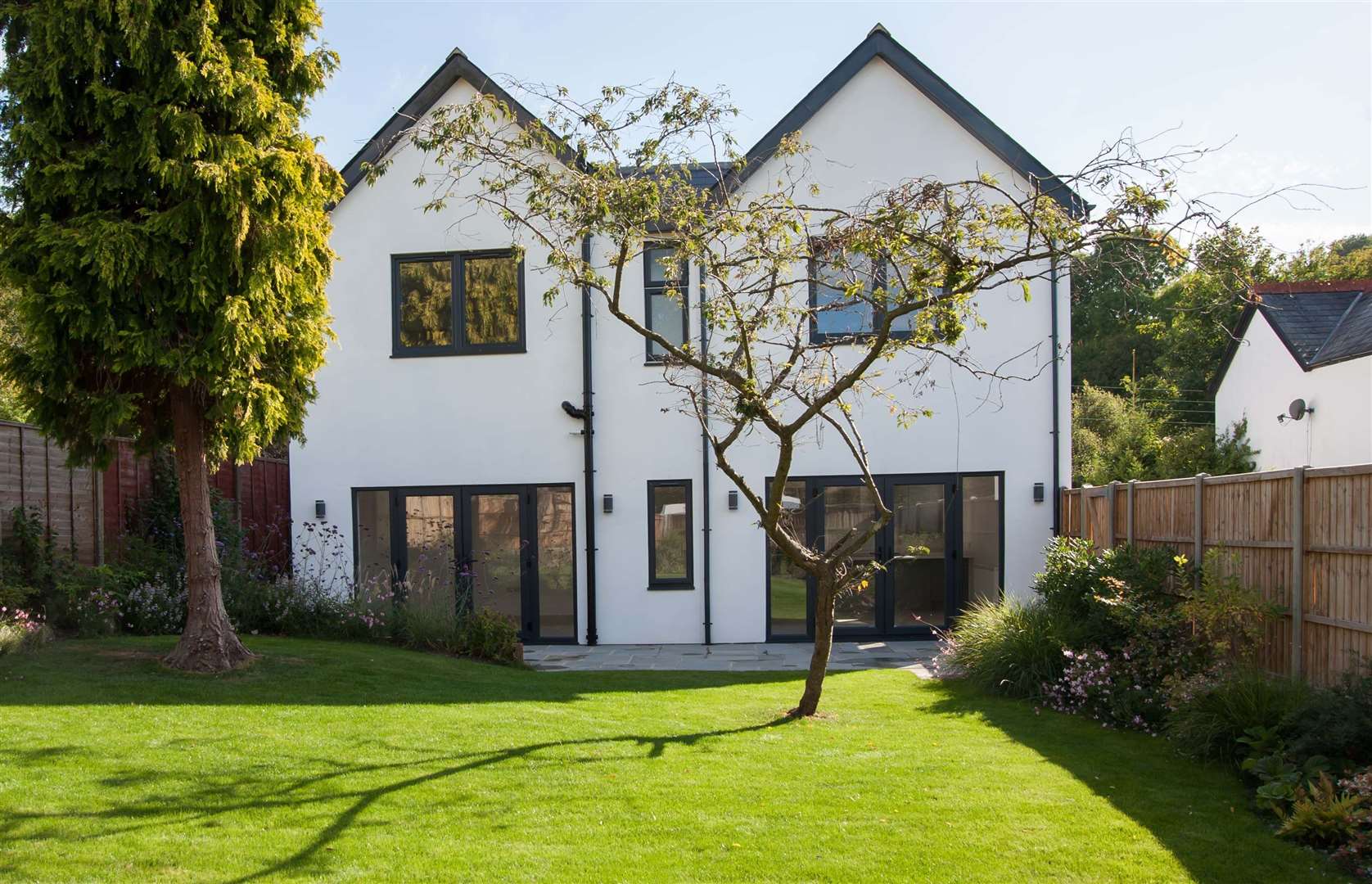 Doors lead from open-plan living space to the garden