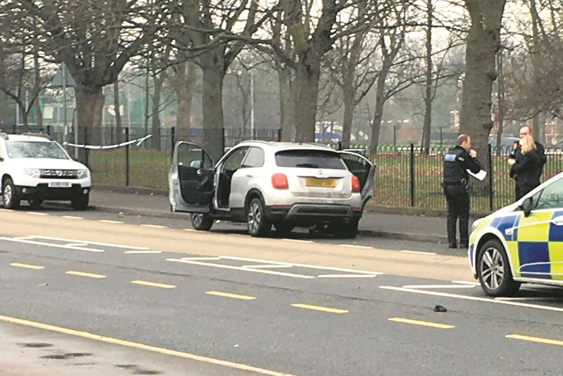 Police looking at the car.