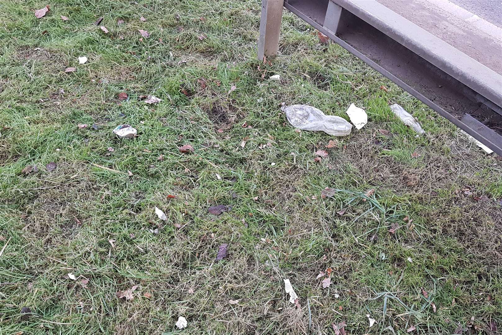 Shredded plastic bottles can be seen on the A2070 verges