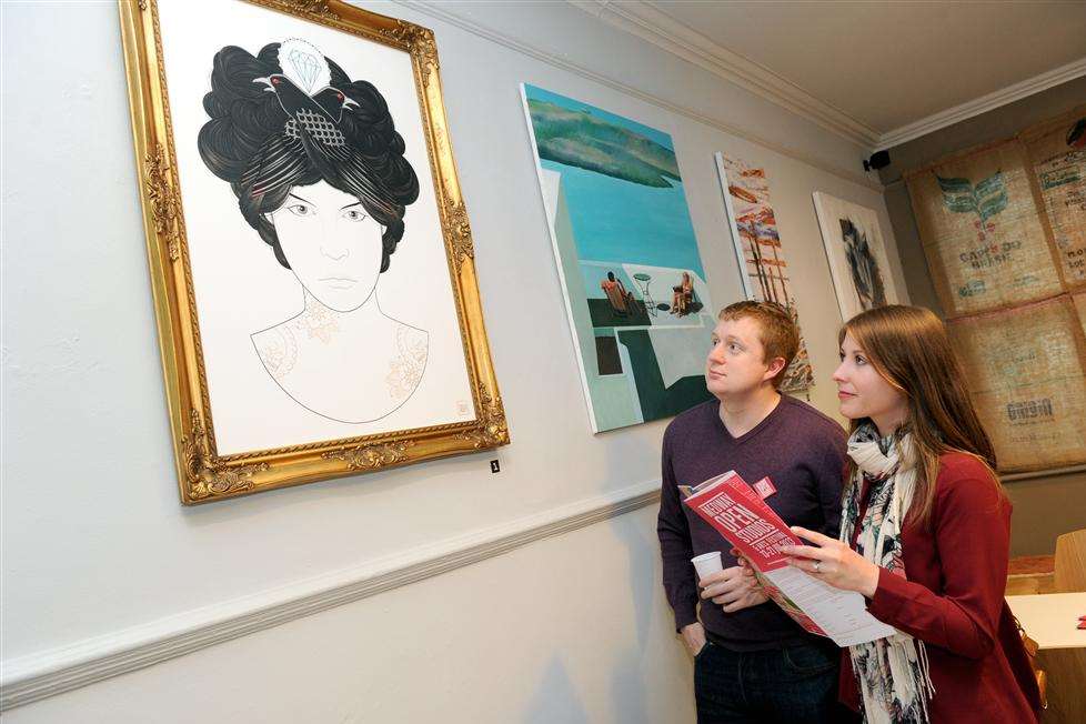 David and Rebecca Lewis looking at some of the artwork