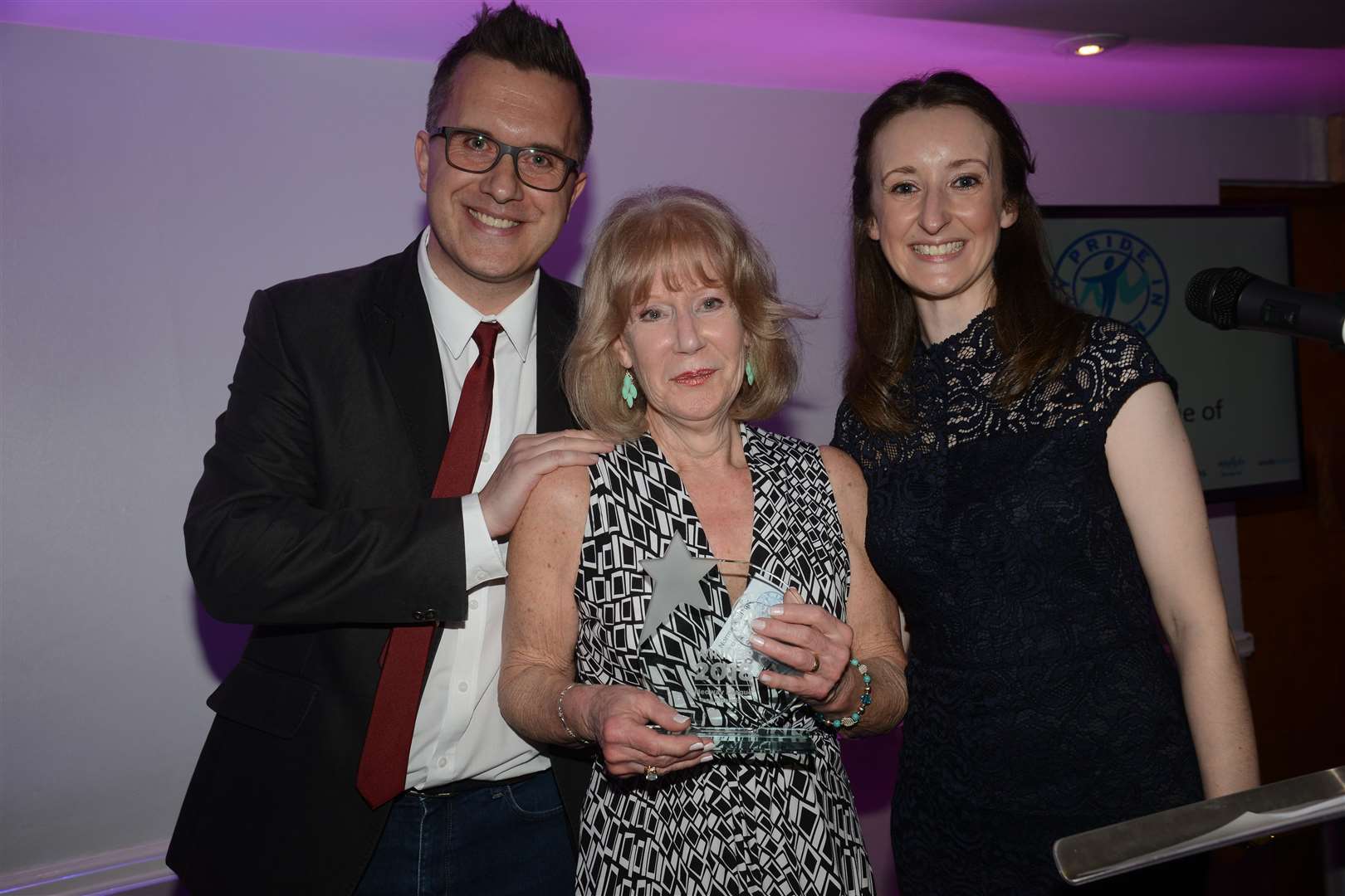 Norma Williams collects the 2018 trophy on behalf of the Medway League of Friends