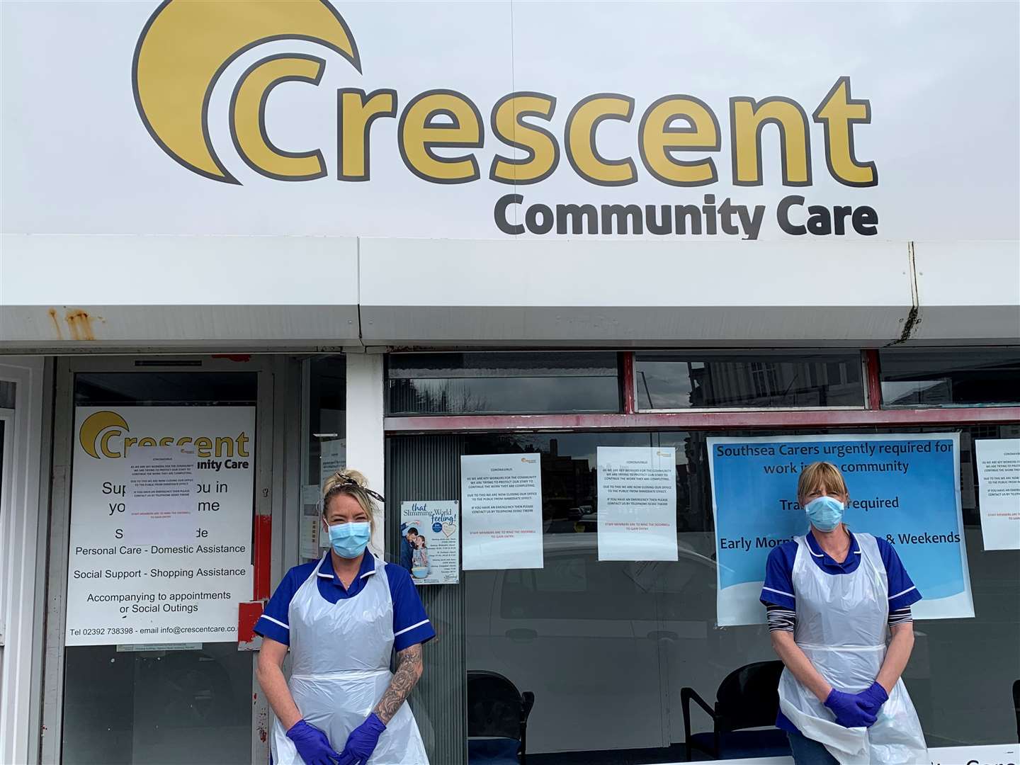 Crescent Community Care staff wearing their personal protective equipment, outside their office (Crescent Community Care/PA)