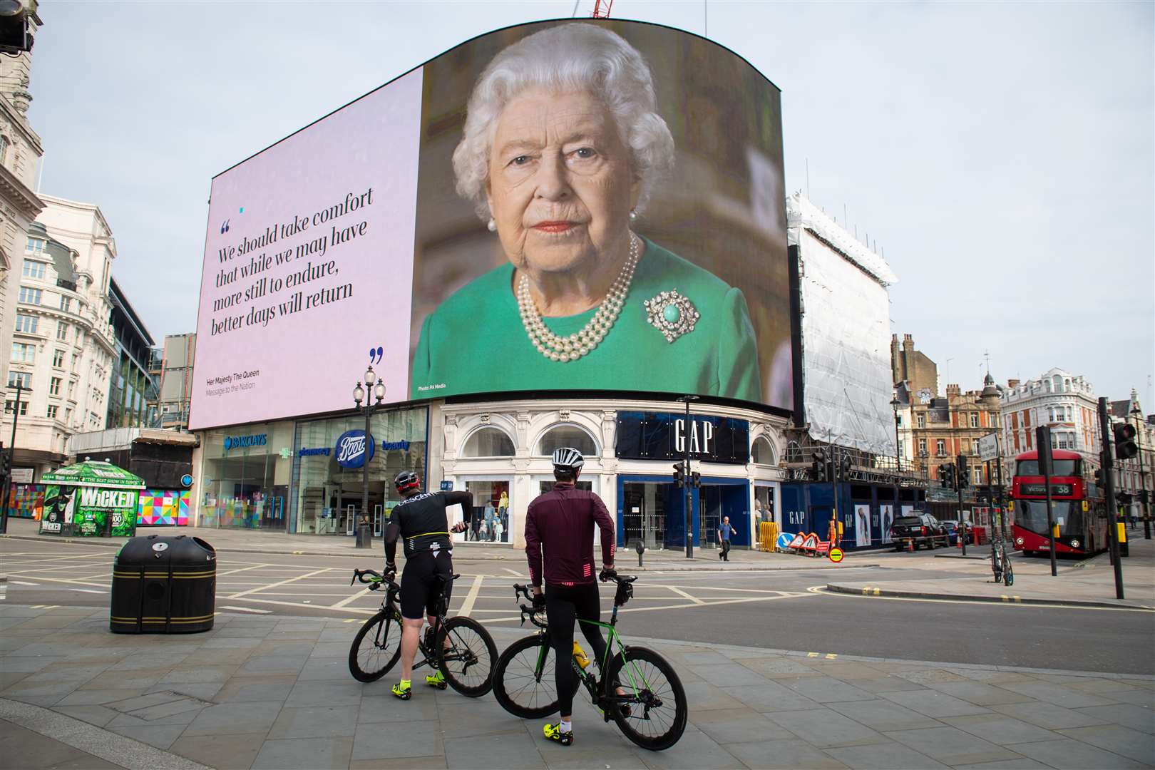 Quotes from her broadcast to the UK and the Commonwealth are displayed in London’s Piccadilly Circus (Dominic Lipinski/PA)