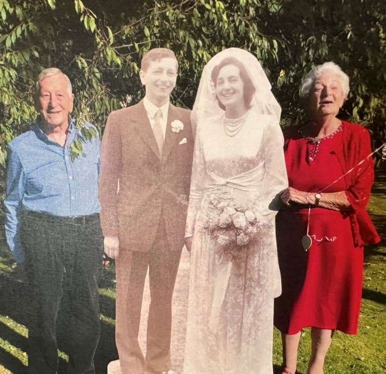 Mr and Mrs Fasey alongside a cardboard cut out of them on their wedding day, taken at a previous anniversary celebration