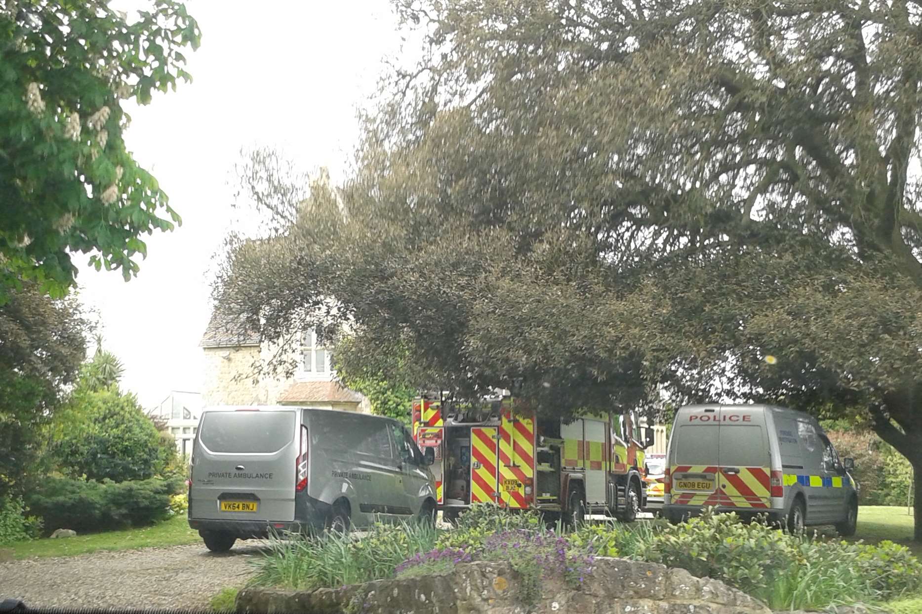 Emergency vehicles outside the house yesterday, when a man in his 50s was found dead.