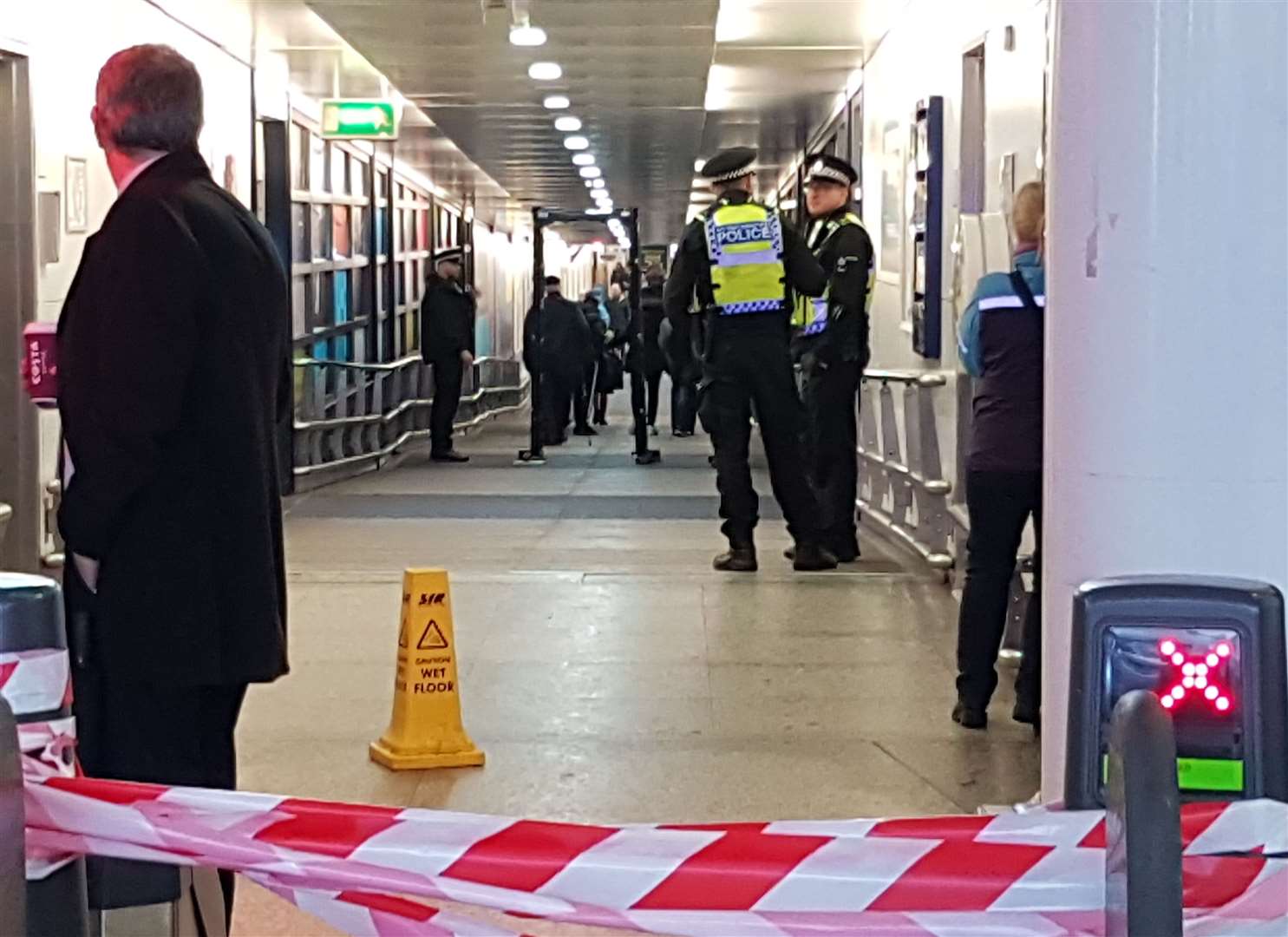 Scanners can be seen beyond the ticket gate at Ashford International station