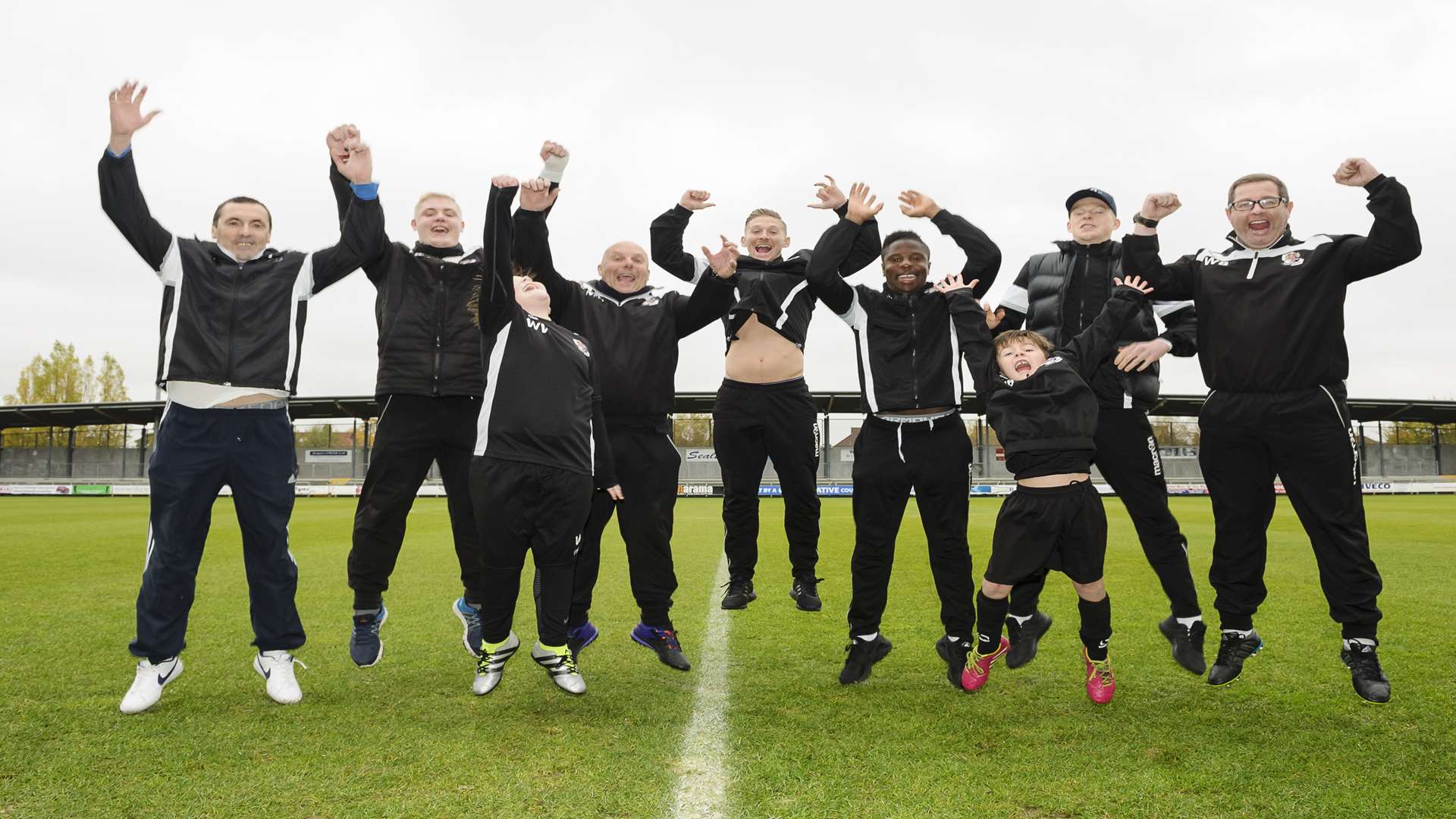 Kids, youth coaches and first team players Andy Pugh, Kaka Dembele and Ben Francis celebrate