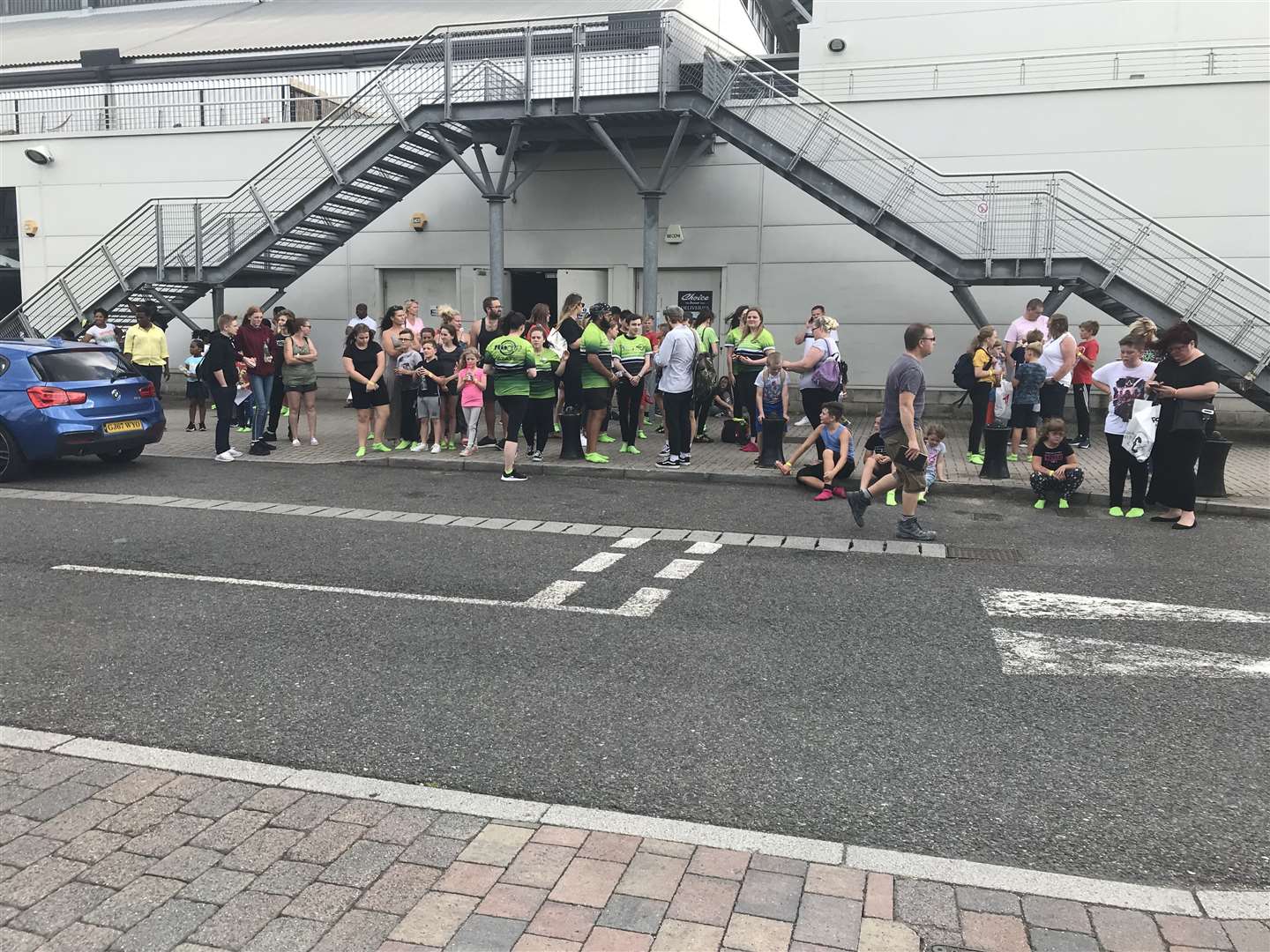 Shoppers and gym goers stand outside the Dockside Outlet after the power cut