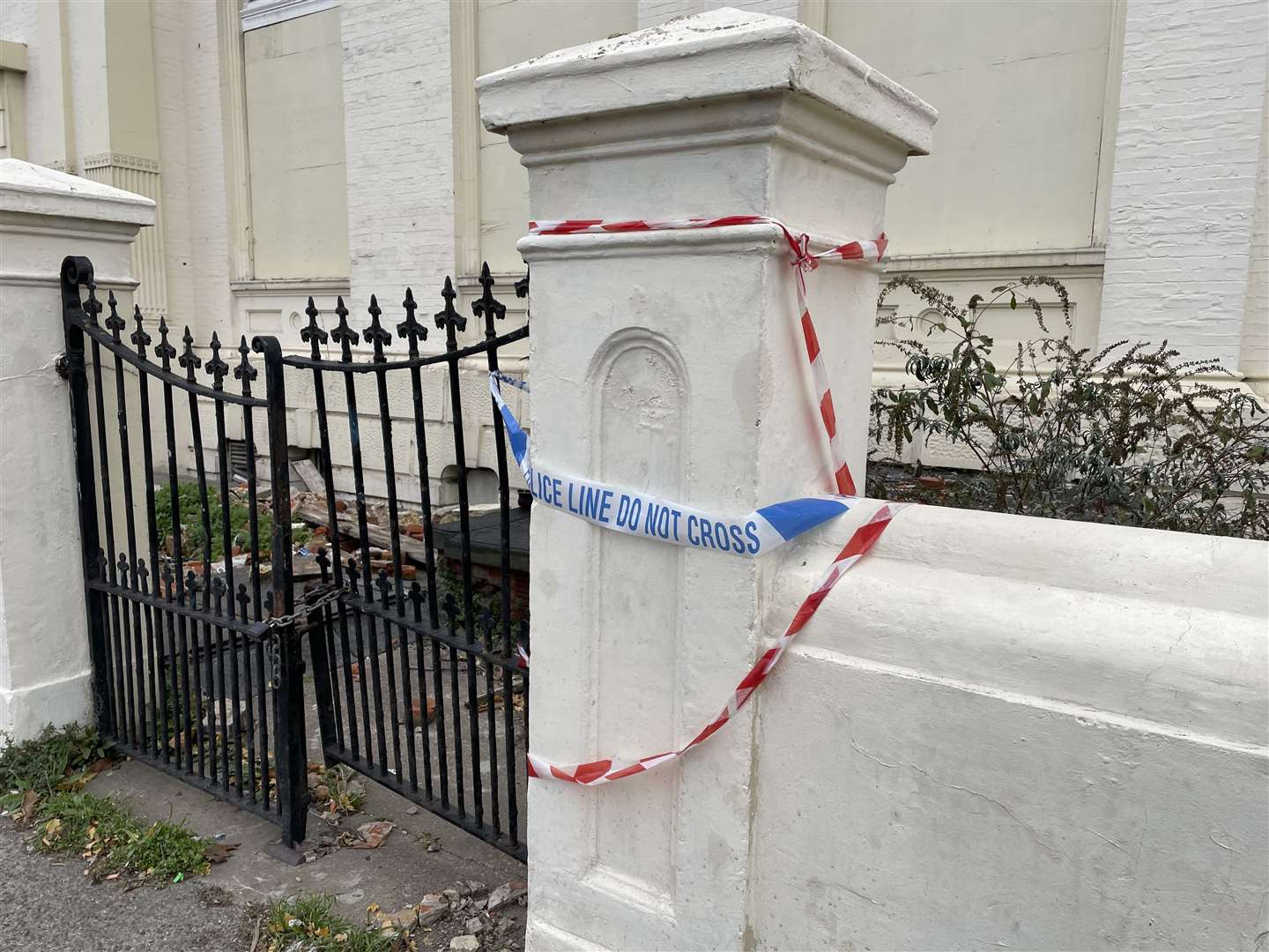 Remnants of police tape outside the building this morning